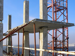 Naklejka premium Precast concrete elements of the building at height. The frame of columns and plates is fastened with steel supports