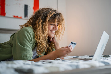 adult woman caucasian female hold credit card online shopping at home