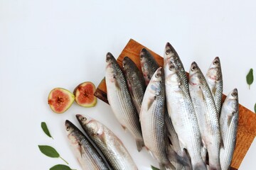 Mullet fish, seafood, on a white background, on the kitchen table, healthy eating, top view, place for text, free space, background for presentations