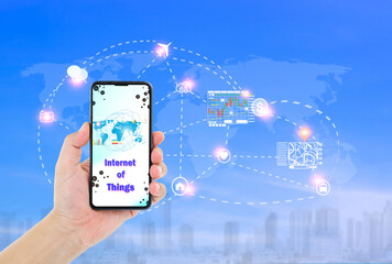Man hand holding smartphone with Internet of things word on screen and icons connecting together,...