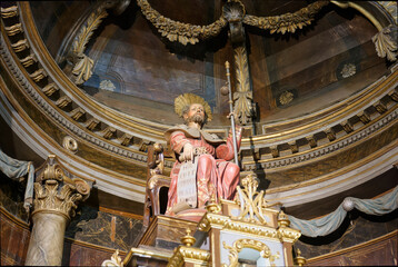 Fototapeta premium polychrome sculpture of the baroque altar with the image of Saint James the Greater on his throne dressed as a pilgrim heading to Santiago de Compostela