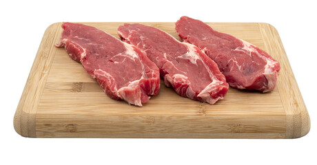 raw beef ribeyes on a wooden board