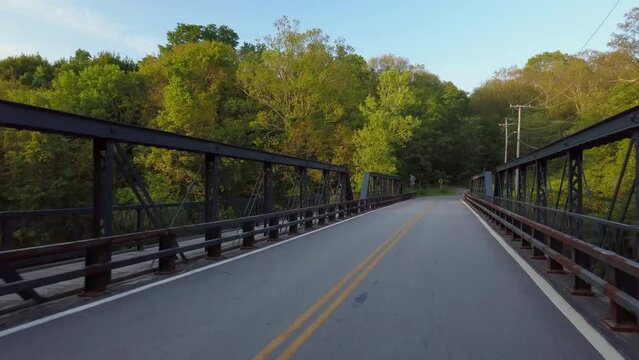 Aerial: Drone Shot Of Empty Road On Bridge Passing Through Trees Against Sky - Boston, Massachusetts
