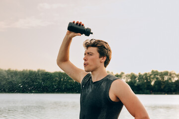 young athlete refreshing with water after workout