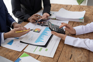 Meeting room atmosphere, business people meeting together on finance topics, they are working together to plan and solve corporate finance issues. Concept of business administration and finance.