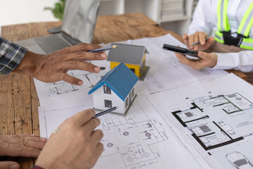 Interior designers and engineers and architects work together to plan the construction of the house...