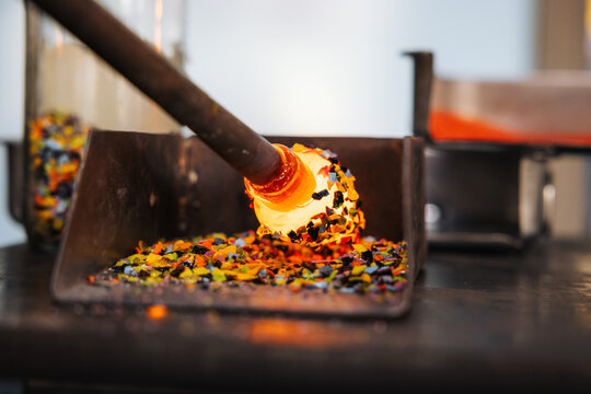 Glassblower crafting a Christmas bauble, from the heat of the oven to shaping it. Workshop based in France.