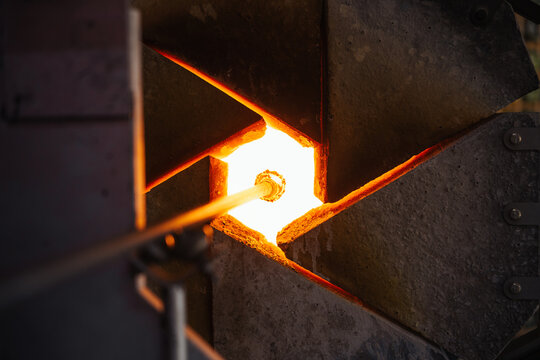 Glassblower crafting a Christmas bauble, from the heat of the oven to shaping it. Workshop based in France.