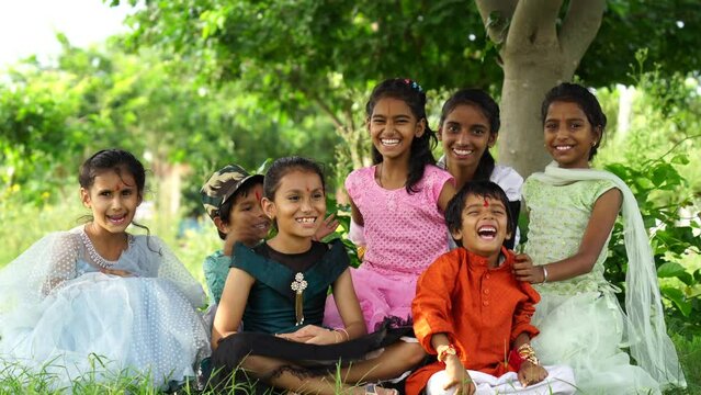 Indian cute little girls and boy enjoying life, smiling and celebrating indian festival rakhi or bhai duj