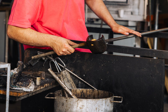 Glassblower crafting a Christmas bauble, from the heat of the oven to shaping it. Workshop based in France.