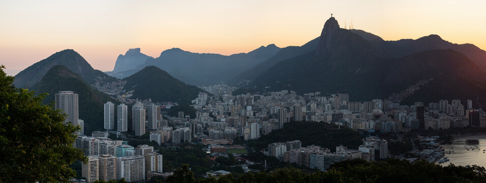 Rio de Janeiro, Brazil: panoramic view at sunset from Sugarloaf Mountain with view of Humaitá district, the Christ the Redeemer on top of Mount Corcovado, Botafogo district and beach