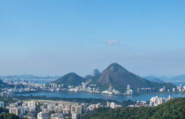 Fototapeta na wymiar Brazil: the postcard skyline of Rio de Janeiro seen from Rocinha, the most famous favela of the city, with view of mountains, skyscrapers, lagoon, Guanabara Bay and Atlantic Ocean