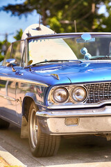 Vintage 60s classic convertible car with surfboard.