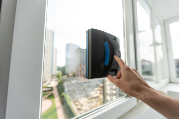 The white robotic window cleaner uses a brush and vacuum for a thorough cleaning. The automatic window washer is a great help for housekeeping tasks.