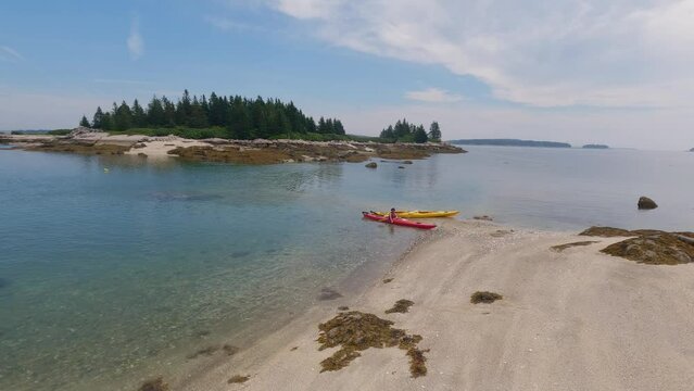 View of small islands archipelago in Stonington, Maine with kayaks in the distance