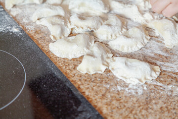 group of raw dumplings lie on granite table.
