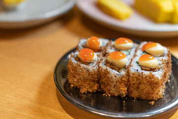 close up of sushi with chopsticks and soy