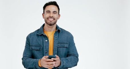 Man, phone and face in studio, celebration and fist in air for prize, profit or bonus by white background. Gen z guy, trading and fintech app with smartphone, investment or gambling in virtual casino