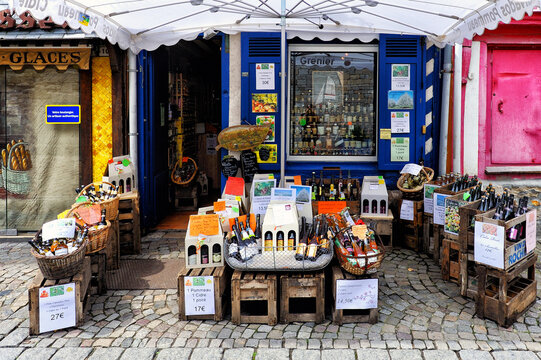Honfleur, Calvados, Normandy, France, Europe - local liquor store with regional alcoholic beverages, wines and alcohols next to bakery shop, Rue de la Ville in historic part of the city