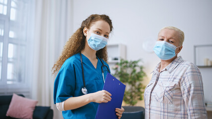 Portrait of woman and doctor in protective face masks, covid-19 prevention - obrazy, fototapety, plakaty