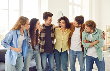 Portrait of a group of young happy smiling friends students or colleagues in casual clothes...