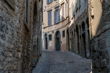 Fototapeta na wymiar Narrow stone street in historical Bergamo, Italy