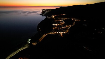 Aerial image captures a stunning view of a landscape lit up with lights at night