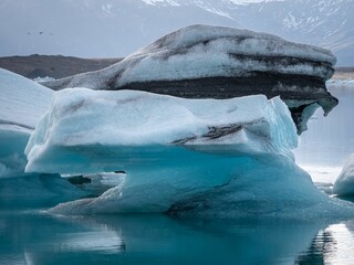 Stunning view of several icebergs peacefully floating on a tranquil lake