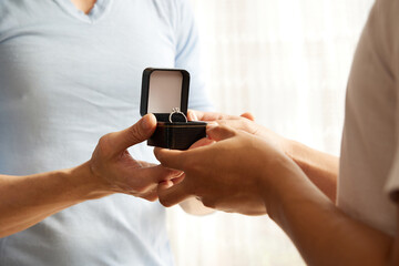 close up young couple showing engagement ring for a marriage proposal.