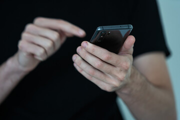 Close up of a man using mobile smart phone