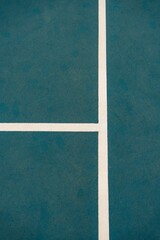 Top view of a tennis court with lines.