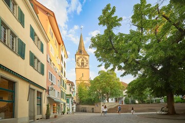 Obraz premium Diverse group of people walk in the city streets in the vicinity of St Peter's Church in Zurich