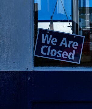 Sign in a shop window declaring "We Are Closed" located in the United Kingdom