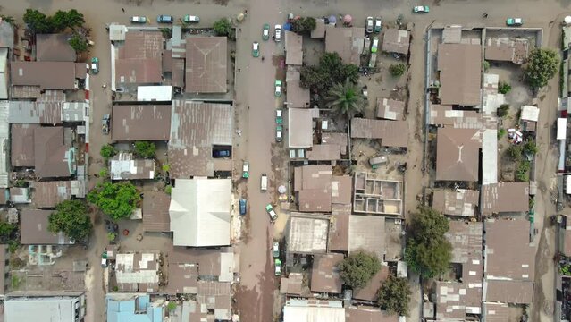 Top view of the traffic on the road alongside the poor houses