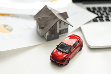 Car and house. Miniature car and house on white background.