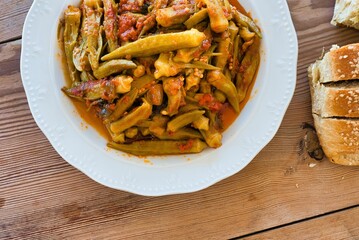 traditional Greek food for the summer, okra in a pot, with fresh tomatoes, on a plate