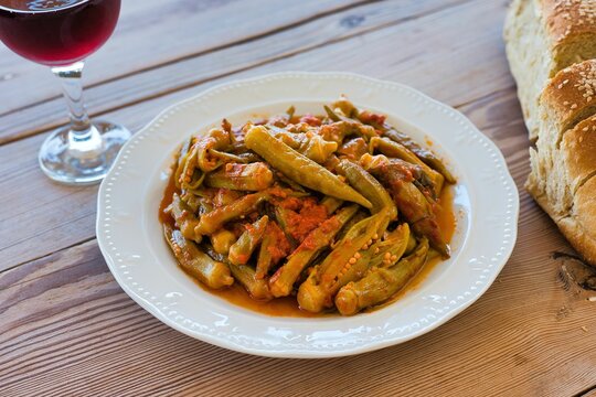 traditional Greek food for the summer, okra in a pot, with fresh tomatoes, on a plate