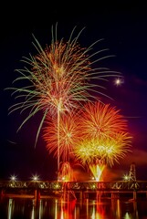 Vibrant festive fireworks over the Meridian Highway Bridge at night