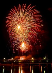 Vibrant festive fireworks over the Meridian Highway Bridge at night