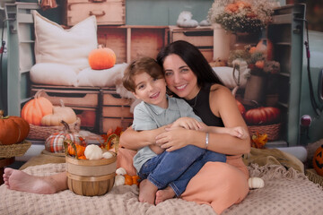 family posing for a autumn photo in the back of a pickup truck 