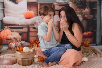 family posing for a autumn photo in the back of a pickup truck 