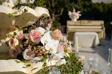 Closeup of a bouquet of roses on a fountain at a wedding