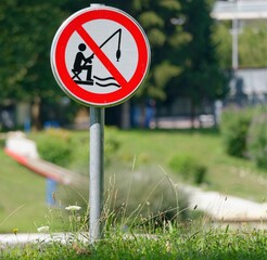 Sign of "No Fishing" on a green shrub
