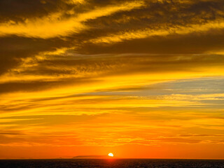 Beautiful sunset by the sea in Sardinia, Italy.