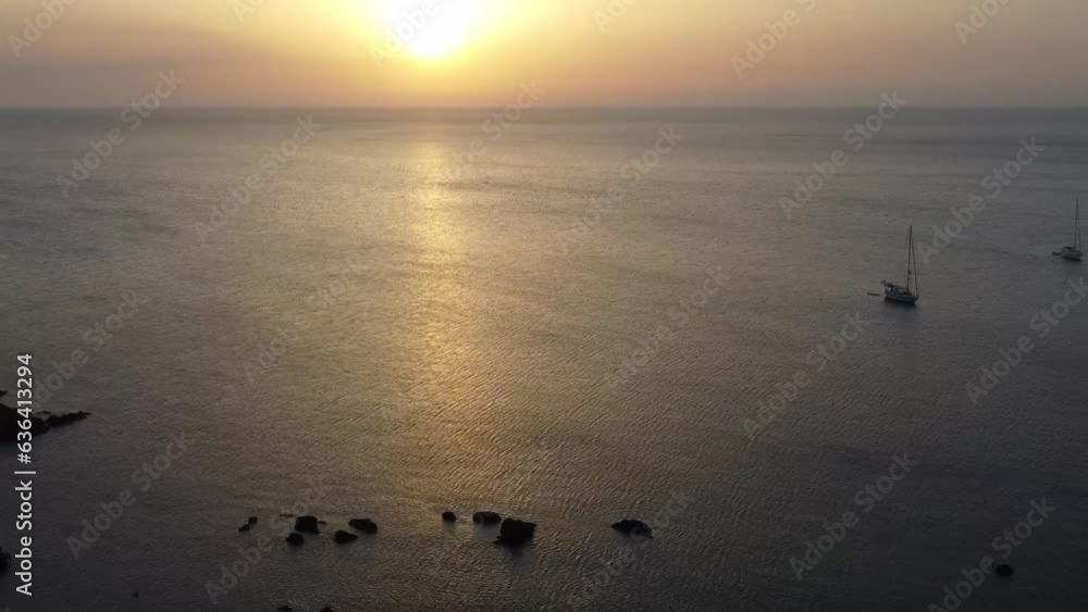 Canvas Prints Drone sunset footage over ships by green range mountains