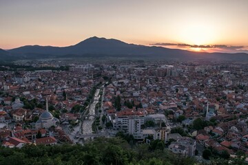 Elevated cityscape view of the city of Prizren, Kosovo, during sunset on a summer day.