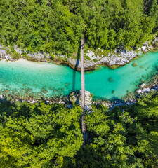 An aerial view above the footbridge over the Soca river in Slovenia in summertime