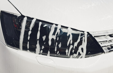car in foam on carwash, car cleaning.