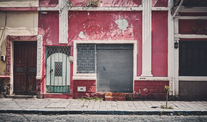 Street view of an old building facade, architecture background, color toning applied, Riobamba, Ecuador. - obrazy, fototapety, plakaty