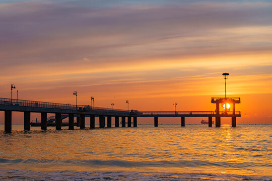 Silhouette shot of the Bridge in Burgas with a golden sunset over the sea